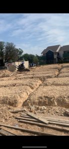 Trenching out for plumbing rough-in for 16 unit multifamily building 1